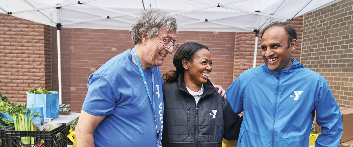 Two staff and a volunteer standing together