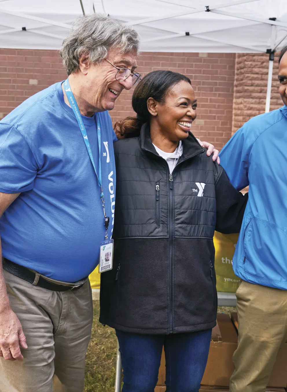 Two staff and a volunteer standing together