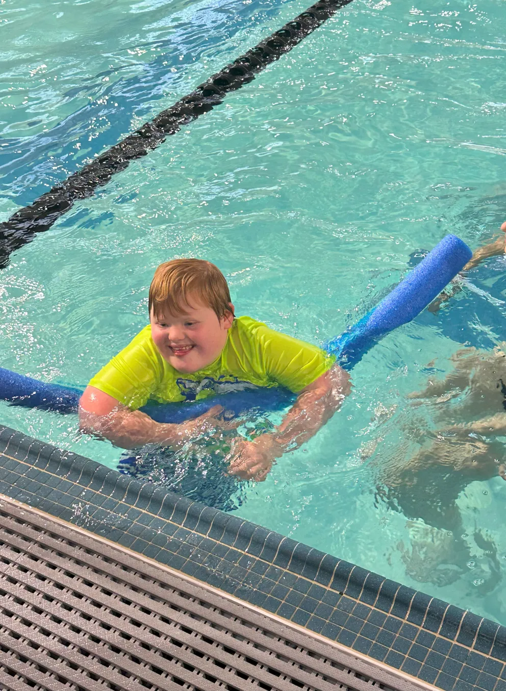 Boy with down syndrome swimming