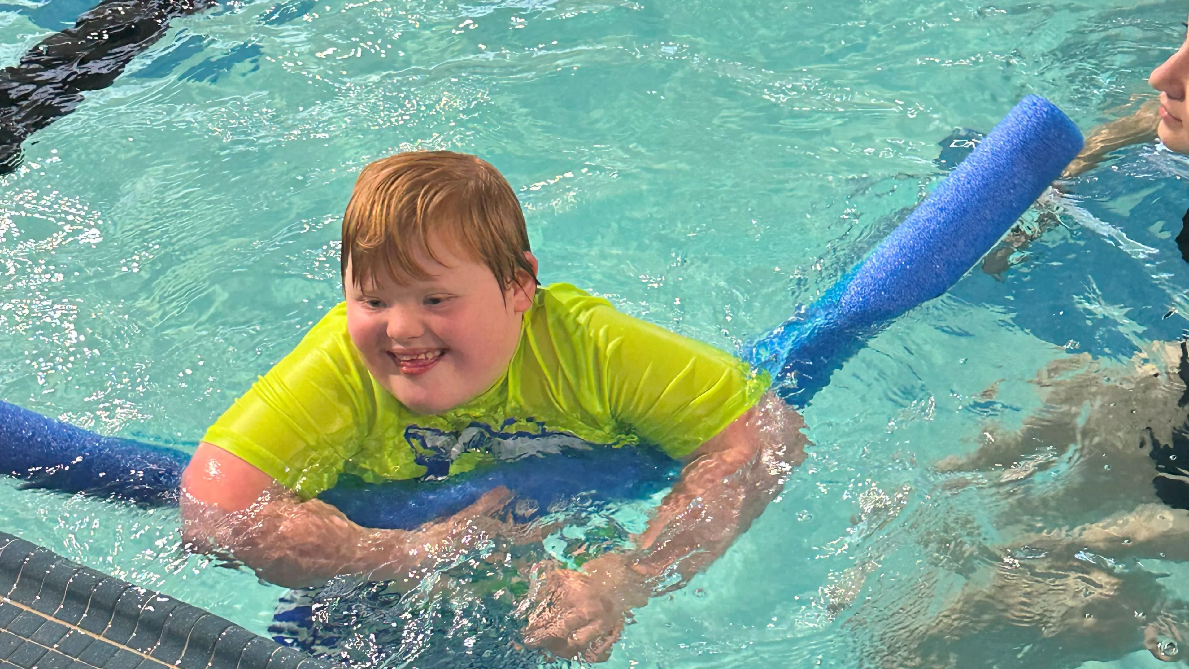 Boy with down syndrome swimming