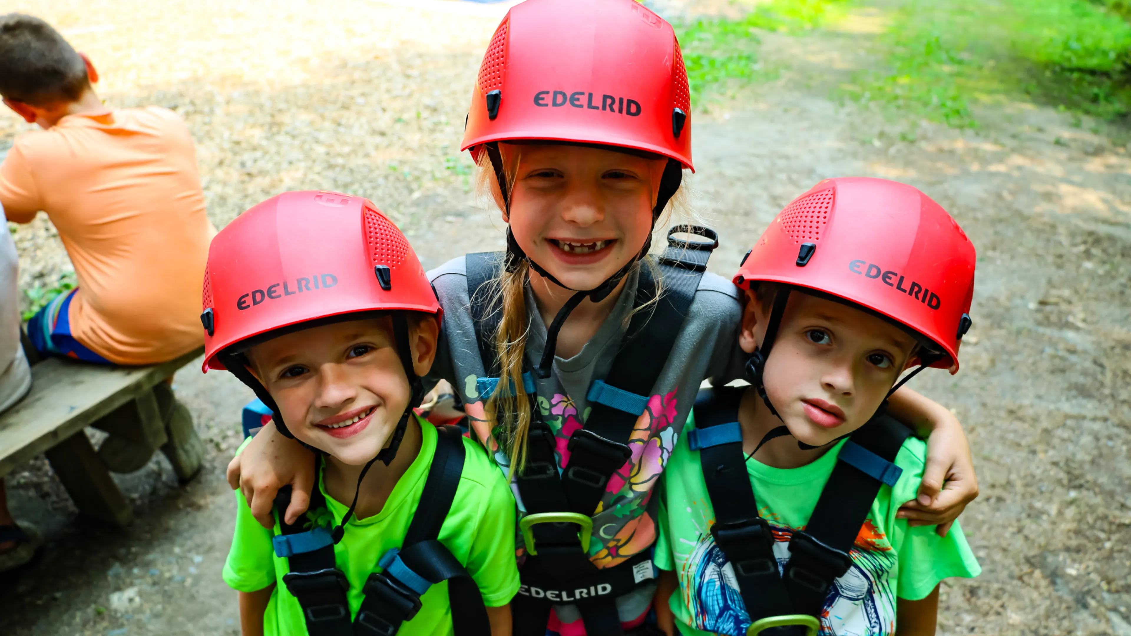 Three Kids SMiling at Summer Camp in Rock Climbing Gear