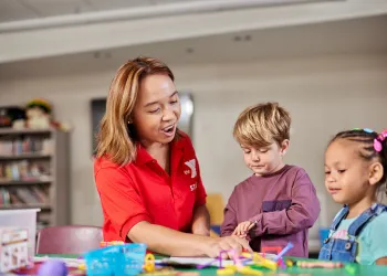 Female staff working with 2 kids
