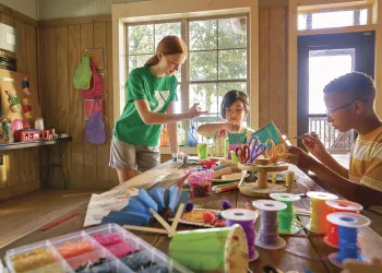 Two kids taking an art class with an instructor.