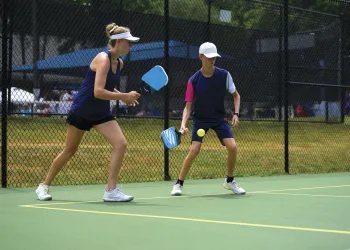 Woman and boy playing pickleball