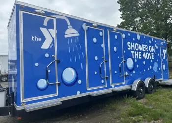 Blue trailer that says "Shower on the Move" with bubbles.
