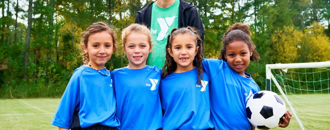Female soccer coach with four girls