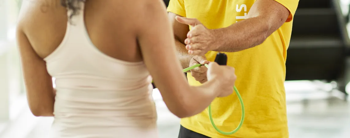 Male trainer working with female client