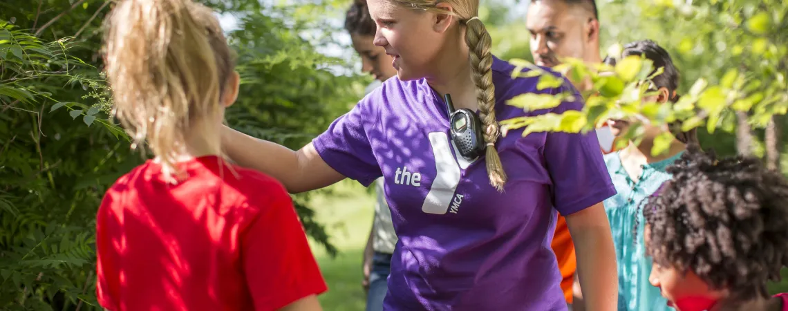 Female counselor showing campers nature