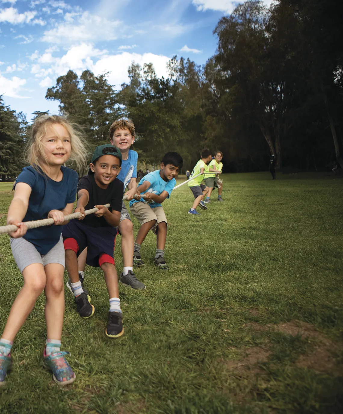 Girls and boys playing tug of war