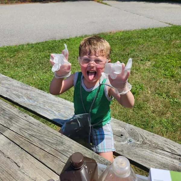 Boy doing a science experiment on a picnic table